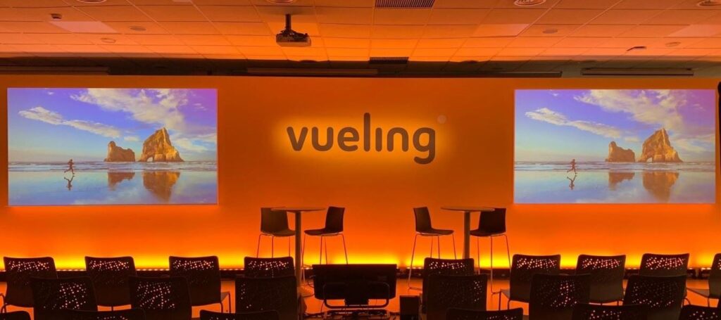 Conference Stage Design - Backdrop with Front Projection Screens for Vueling